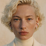 Model wearing Mini Verta Earrings, editorial portrait in cream tones