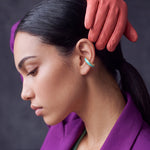 Aqua Insight aqua blue enamel gold-plated ear cuff on a model in a purple blazer with leather gloves
