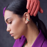 Aqua Insight aqua blue enamel gold-plated ear cuff on a model in a purple blazer with leather gloves