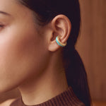 Aqua Insight aqua blue enamel gold-plated ear cuff, close-up on the ear