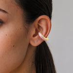 Blush Serenity 14K gold-plated ear cuff with powder pink enamel, close-up on the ear