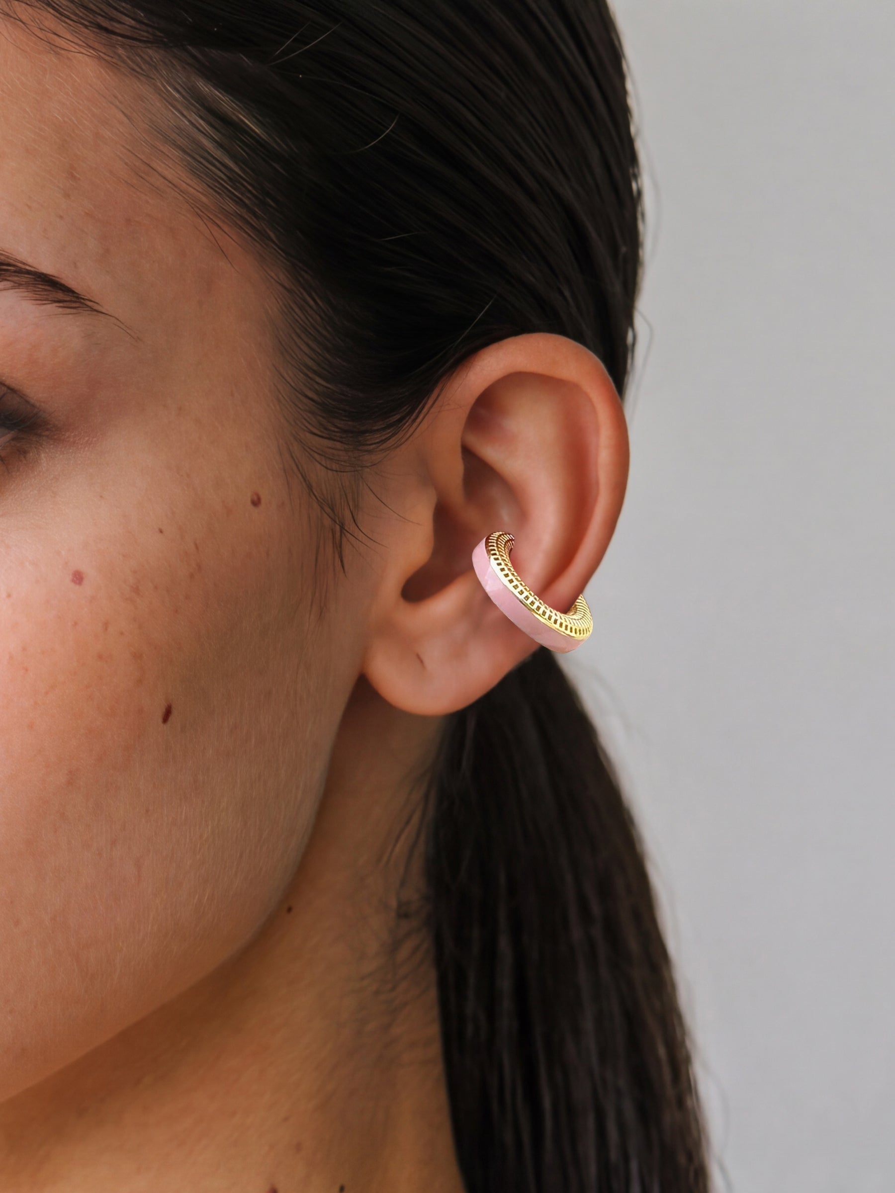 Blush Serenity 14K gold-plated ear cuff with powder pink enamel, close-up on the ear