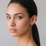 Model wearing the Blush Serenity silver ear cuff with powder pink enamel, minimal portrait