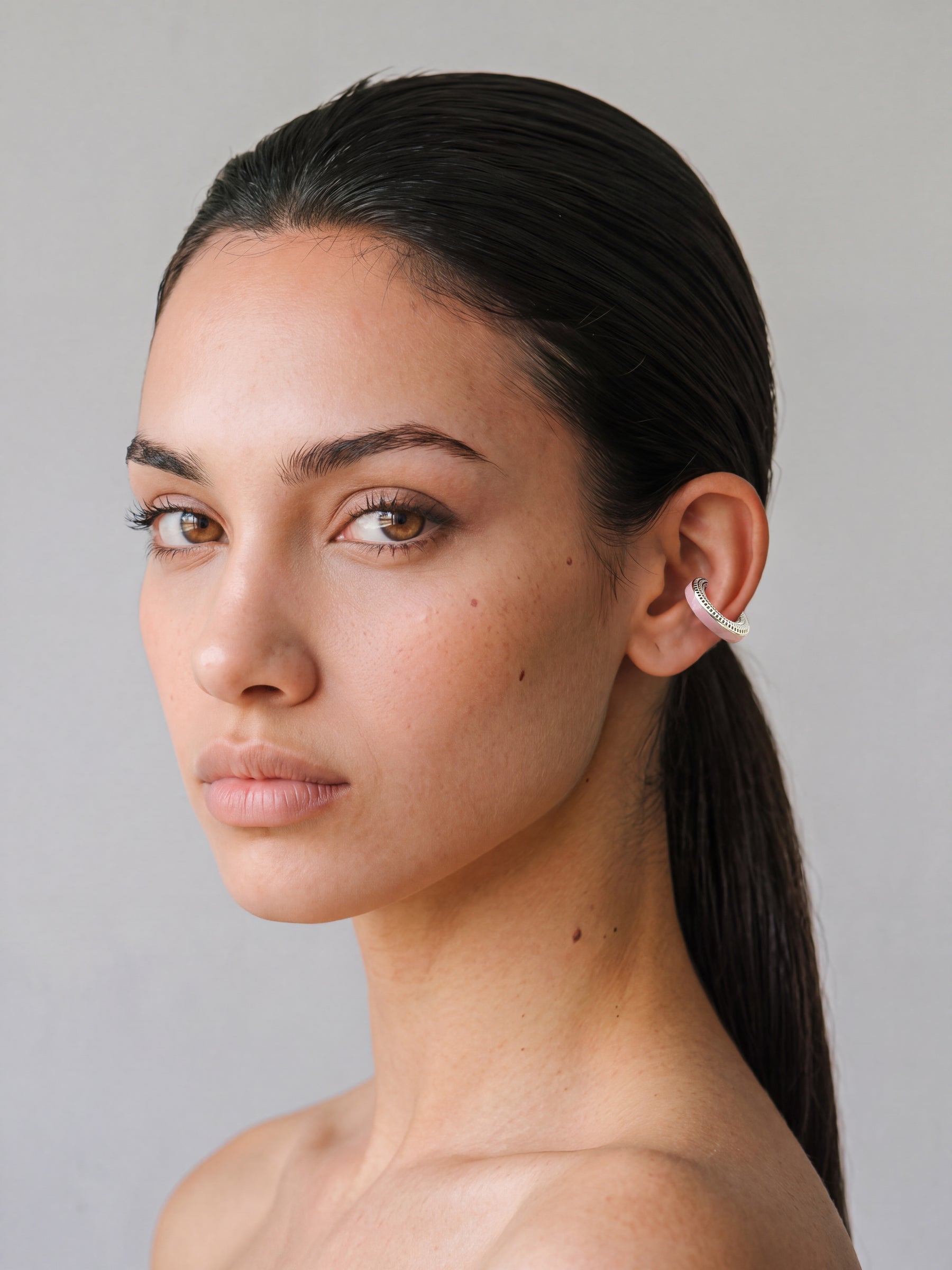 Model wearing the Blush Serenity silver ear cuff with powder pink enamel, minimal portrait