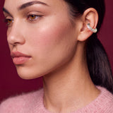 Blush Serenity silver ear cuff with powder pink enamel, model in a pink sweater on a burgundy backdrop