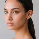 Model wearing the Hola Aura 14K gold-plated ear cuff, close-up portrait