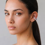 Model wearing the Hola Aura silver ear cuff with butter yellow enamel, minimal portrait