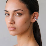 Model wearing the Hola Aura silver ear cuff with butter yellow enamel, minimal portrait
