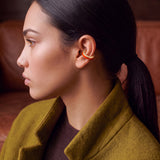 Ignite Pulse ear cuff kulakta yakın çekim, ateş turuncusu mine, 14 ayar altın kaplama 925 ayar gümüş deliksiz kıkırdak küpe, haki paltolu model