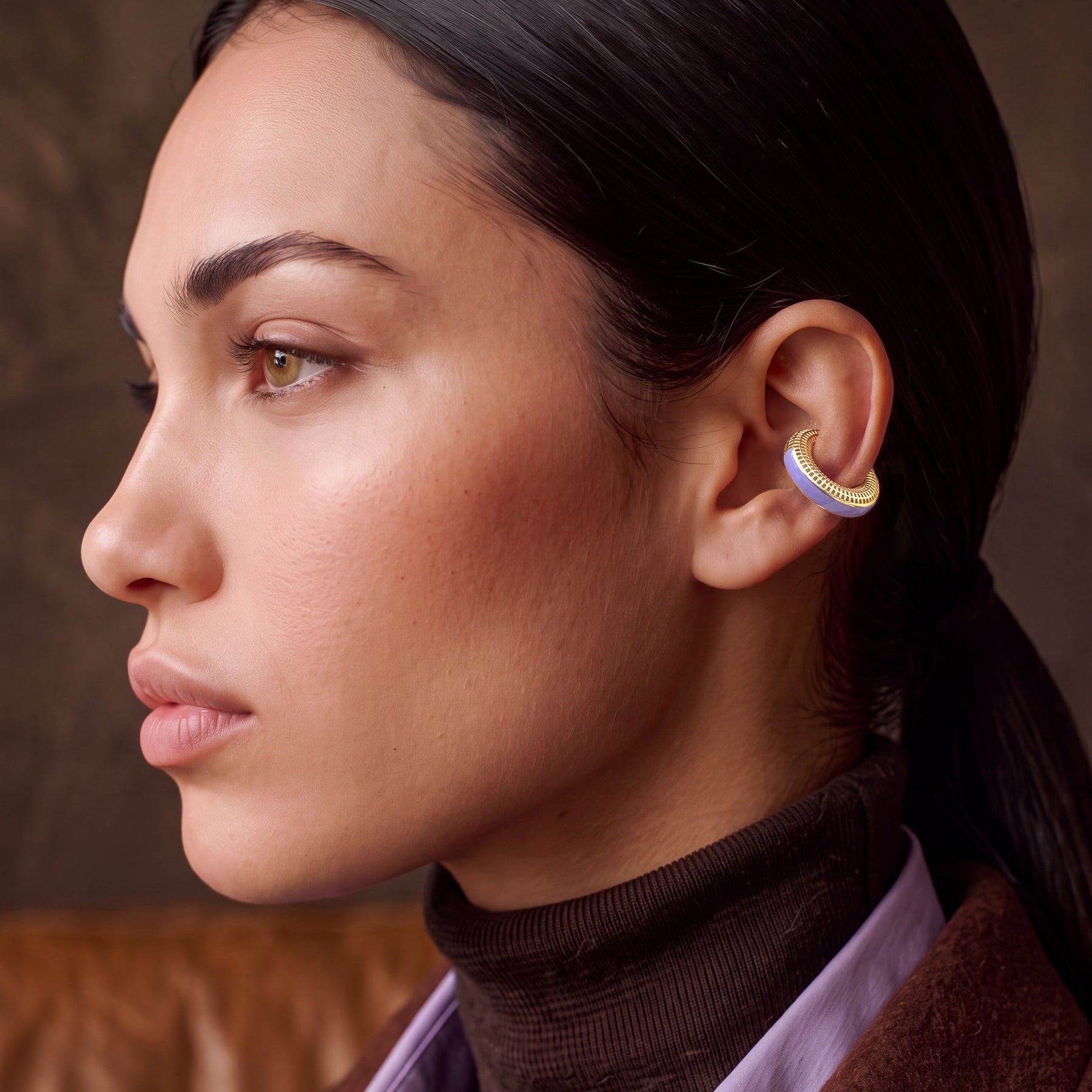 Lilac Reverie 14K gold-plated ear cuff on a model in a brown turtleneck, profile view