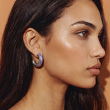 Model in profile against a warm camel backdrop wearing Lilac Reverie lilac enamel silver earrings
