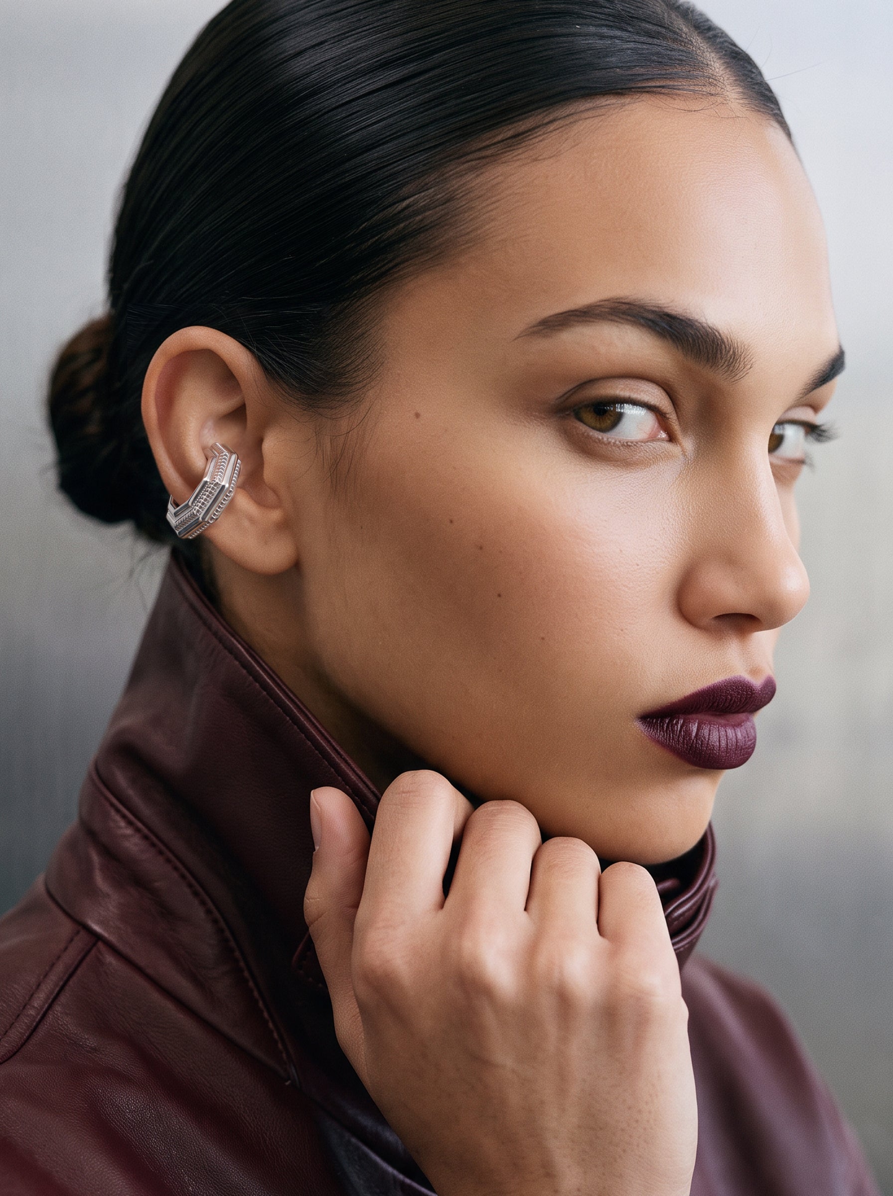 Model wearing the Octa Ear Cuff, burgundy leather jacket, rhodium-plated 925 sterling silver octagonal cartilage cuff