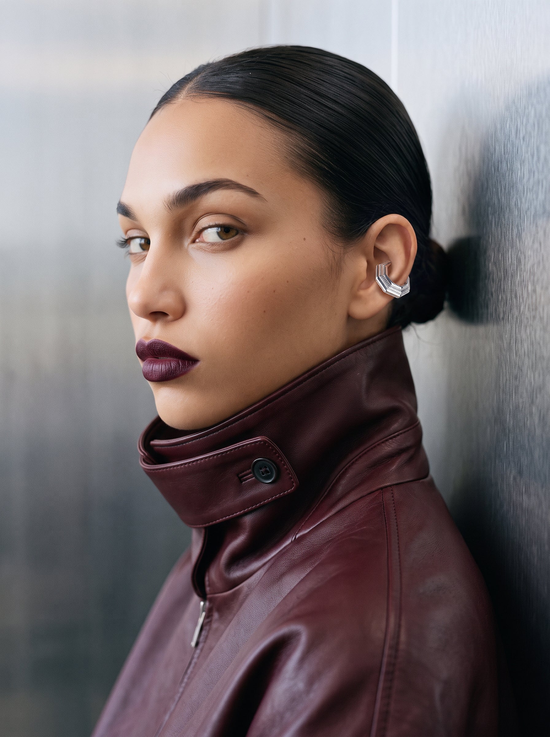 Model wearing the Octa Ear Cuff in profile, burgundy leather jacket, no-piercing 925 sterling silver ear cuff