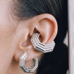 Close-up of the Octa earring with an UNBOUND ear cuff, rhodium-plated 925 sterling silver layered octagonal form