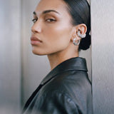Model wearing the Octa earring with an ear cuff, black leather jacket, rhodium-plated 925 sterling silver
