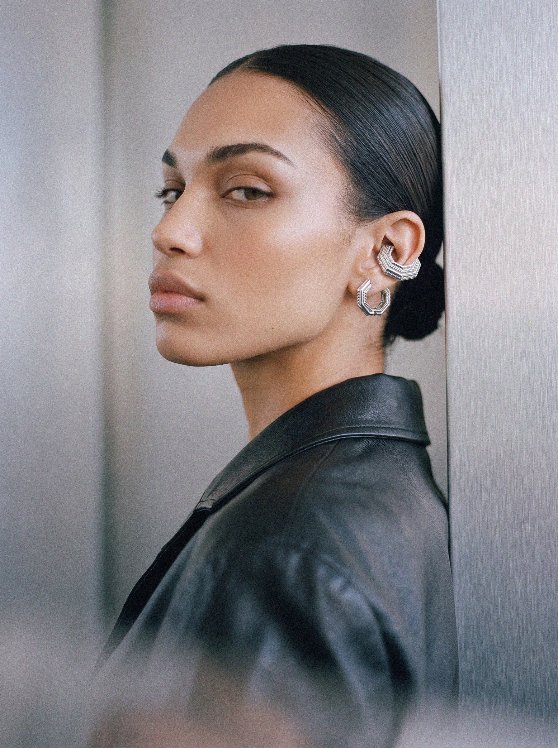 Model wearing the Octa earring with an ear cuff, black leather jacket, rhodium-plated 925 sterling silver