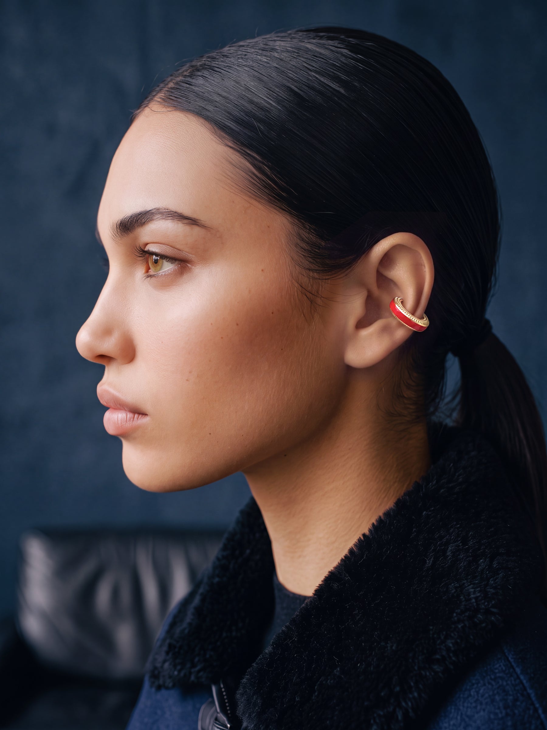 Scarlet Pulse 14K gold-plated ear cuff on a model in a navy jacket, profile view