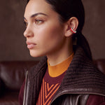 Scarlet Pulse rhodium-plated ear cuff on a model in a leather jacket and burgundy knit