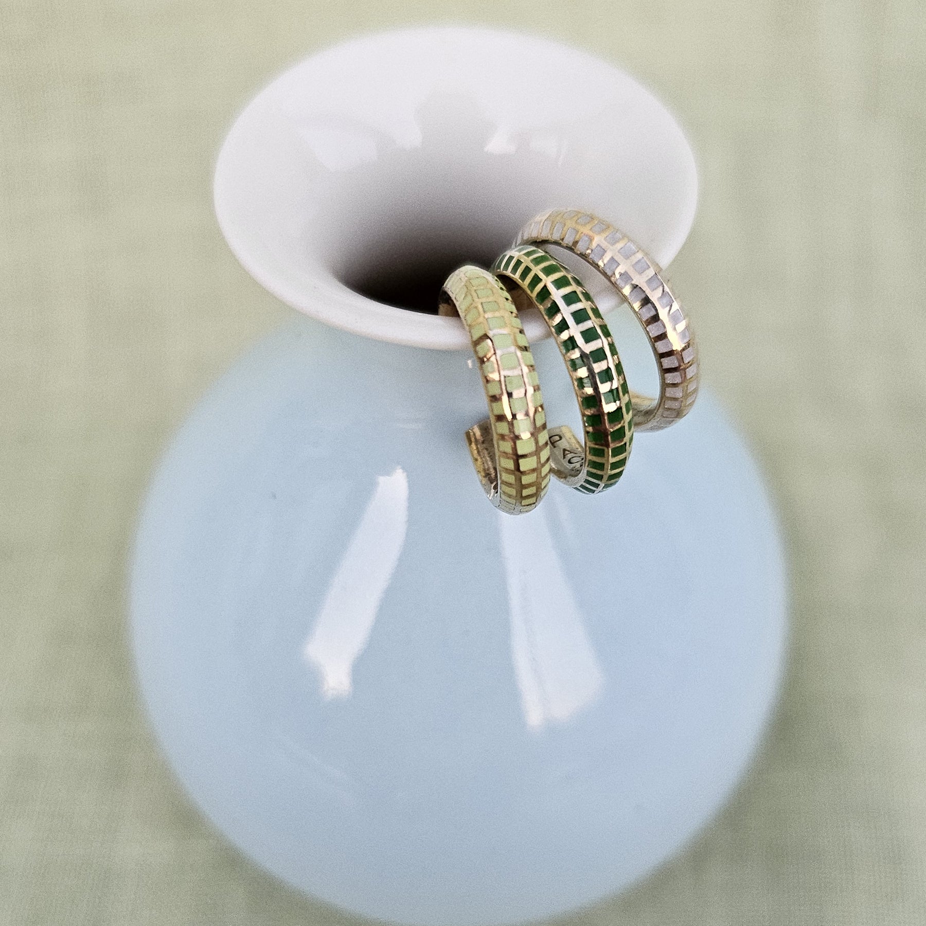 Semita Ear Cuff Set II on a white vase rim, close-up