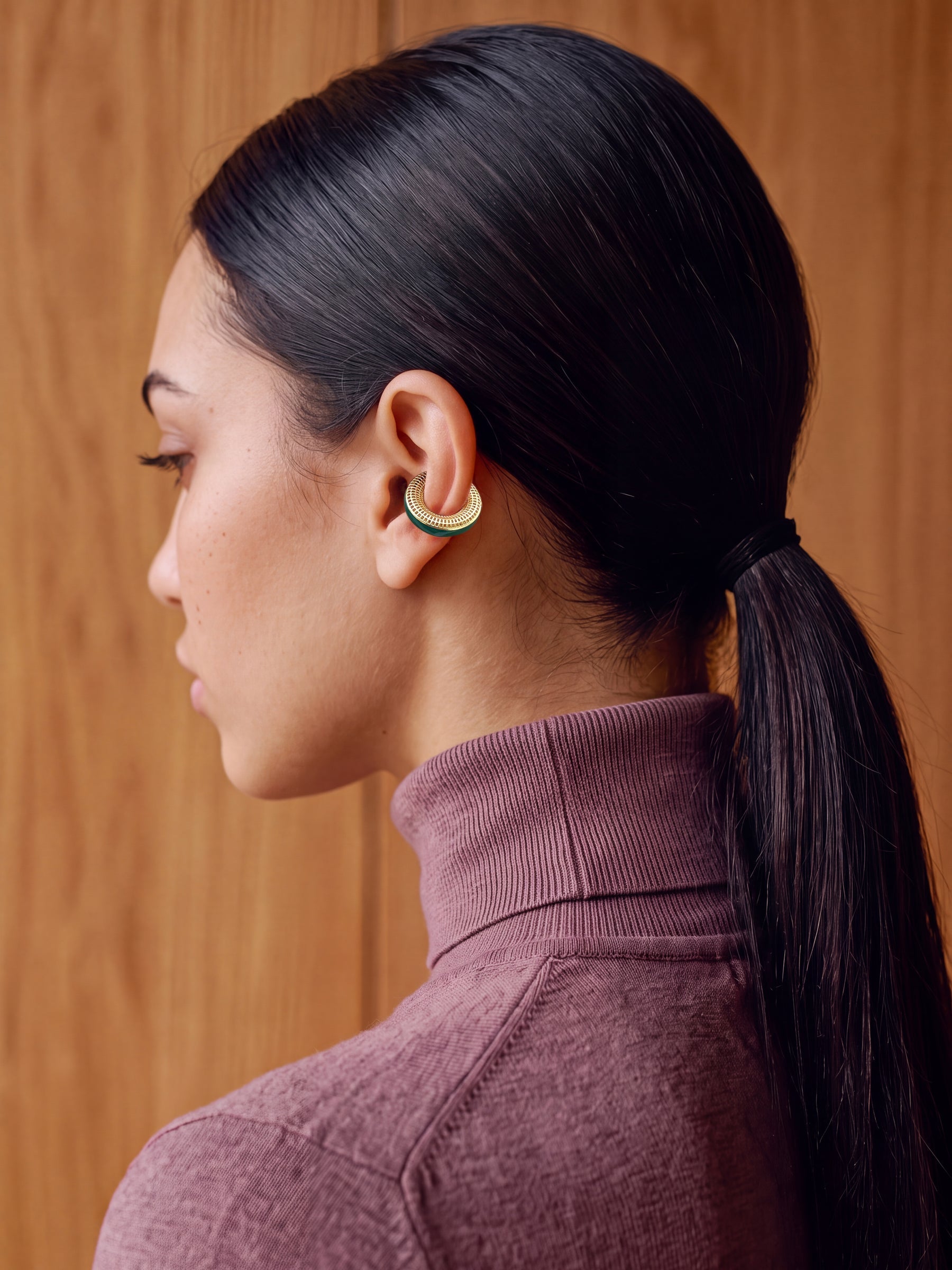 Verdant Poise gold-plated ear cuff on a model with a sleek ponytail, back view